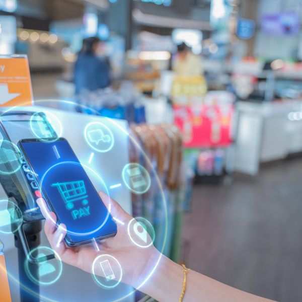 A hand holding a phone while doing mobile payment