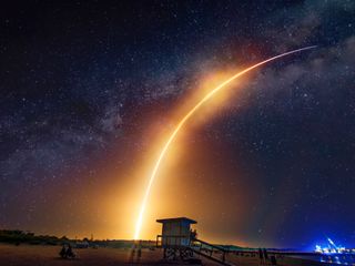 A rocket launch at night on a beach