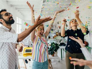 Coworkers celebrating together in their office