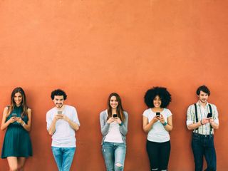 Five people holding a phone