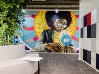 Graffiti of a black woman on a wall in a CI&T office