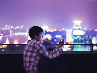 Man looking at smartphone on the roof