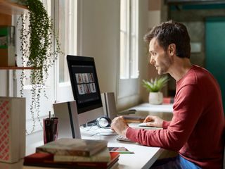 Man using computer while sitting at table