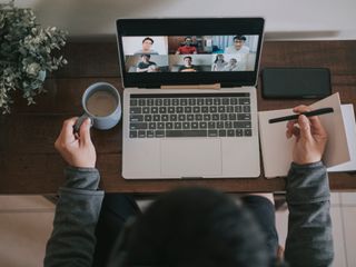 Man working at home using laptop and having a virtual meeting