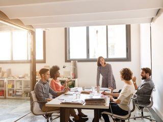 Multi-ethnic business people discussing at conference table in board room