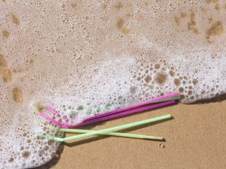 Plastic straws washing up on a beach
