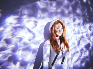 Portrait of a woman standing with blue light