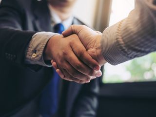 Two business men shaking hands during a meeting