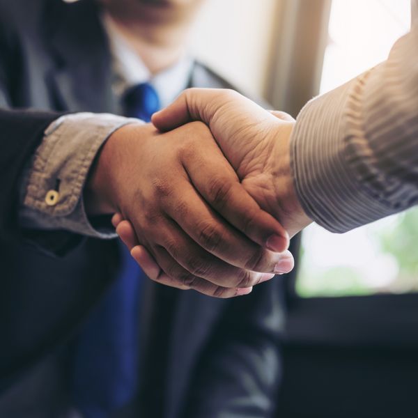 Two business men shaking hands during a meeting