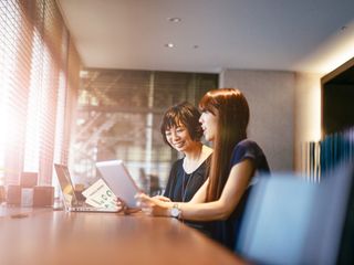 Two women smiling in an office