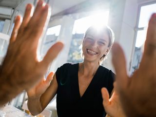 Woman high fiving a colleague