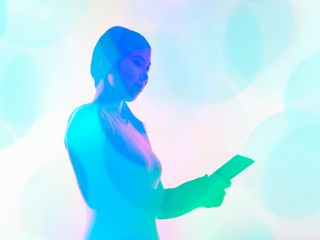Woman holding a tablet with a blue filter
