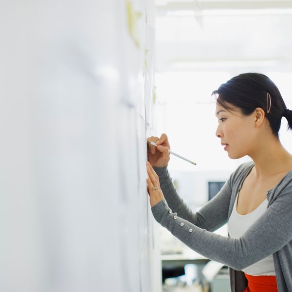 Woman writing on a whiteboard